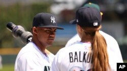 FILE - Rachel Balkovec coaches Jasson Dominguez during American League batting practice of the MLB All Star Futures game, July 11, 2021, in Denver.