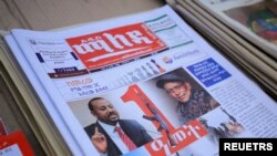 Ethiopia’s Prime Minister Abiy Ahmed and leader of the Tigray People's Liberation Front (TPLF) party Debretsion Gebremichael are pictured on the Maleda Local News papers, showing the conflict marking one year, in Addis Ababa, 