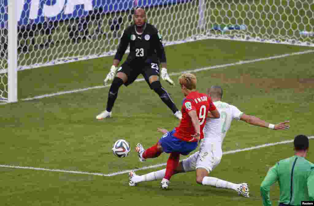 South Korea's Son Heung-min scores past Algeria's Rais Mbolhi during their match at the Beira Rio stadium in Porto Alegre, June 22, 2014.