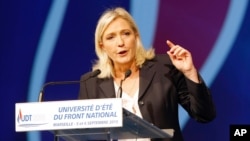 FILE - The National Front's Marine Le Pen, shown delivering a speech in Marseille, France, in September, would lose a runoff in the northern region of Nord-Pas-de-Calais-Picardie, a poll shows.