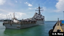 The guided-missile destroyer USS John S. McCain (DDG 56) arrives pier side at Changi Naval Base, Republic of Singapore following a collision with the merchant vessel Alnic MC while underway east of the Straits of Malacca and Singapore.