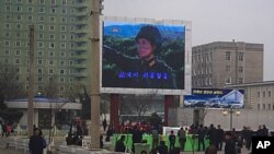A military-themed movie is broadcast on a large TV screen near the train station in Pyongyang, North Korea, April 10, 2012.