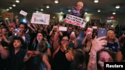 Members of the audience react as they listen to U.S. Democratic presidential candidate Bernie Sanders speak during a rally in the Manhattan borough of New York, June 23, 2016.