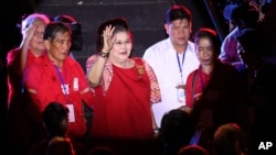 Former first lady Imelda Marcos, center, waves to the crowd as she attends the last campaign rally of her son vice presidential candidate Sen. Ferdinand "Bongbong" Marcos Jr. at suburban Mandaluyong city, east of Manila, Philippines on May 5, 2016.
