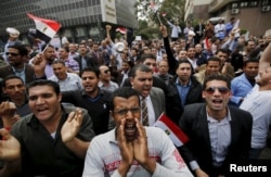 FILE - Unemployed graduates shout anti-government slogans during a protest to demand that the government offer them jobs, in front of the parliament headquarters in Cairo, March 27, 2016, where the nation's prime minister was speaking.