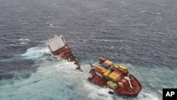 The stricken container ship Rena sits on a reef about 14 nautical miles (22 km) from Tauranga, on the east coast of New Zealand's North Island after it separated into two, January 8, 2012.