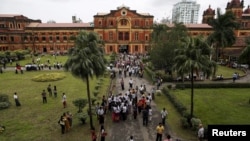 People visit the Ministers' Building, formerly known as the Secretariat building, where General Aung San and eight others were assassinated, during an event marking the anniversary of Martyrs' Day in Yangon, Myanmar, July 19, 2015. 