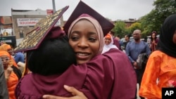 Brooklyn College humanities and social sciences graduate Ameera Badamasi, center, from Nigeria, hugs a student after the college's commencement ceremony, where Sen. Bernie Sanders, I-Vt., delivered the keynote address, May 30, 2017.