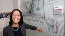 Professor Ya-Chieh Hsu, senior author of the study, shows off a diagram of a hair follicle - complete with a helpful test mouse. Ya-Chieh Hsu has received the Rosslyn-Abramson award for teaching. (Jon Chase/Harvard Staff Photographer)