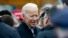 Former vice president Joe Biden talks with officials after speaking at a rally in support of striking Stop & Shop workers in Boston, April 18, 2019.