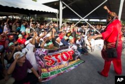 Myanmar ethnic Rohingya Muslims raise clenched fists during a protest against the persecution of Rohingya Muslims in Myanmar, in Kuala Lumpur, Malaysia, Dec. 4, 2016.