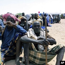Somali's wait for food aid to be handed out from the UNHCR in Mogadishu , Wednesday. Aug. 31.2011