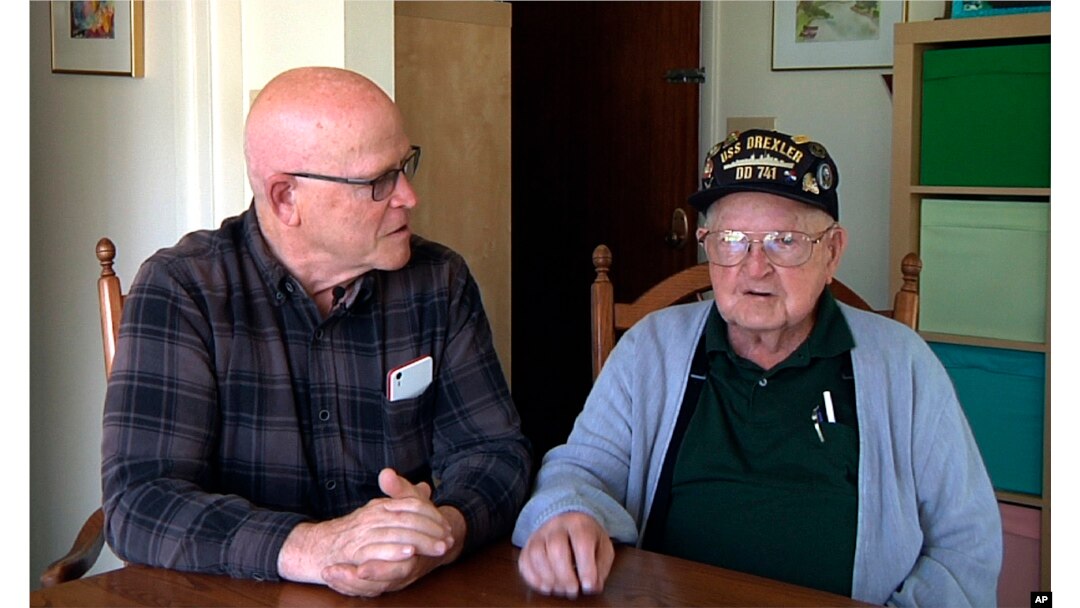 This framegrab from a video shows Gene Brick, 92, right, and his son, Bartt Brick, together in Madras, Oregon, June 12, 2017. The two, who made a telescope together in 1964, plan to watch the upcoming solar eclipse Aug. 21, 2017.
