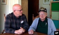 This framegrab from a video shows Gene Brick, 92, right, and his son, Bartt Brick, together in Madras, Oregon, June 12, 2017. The two, who made a telescope together in 1964, plan to watch the upcoming solar eclipse Aug. 21, 2017.