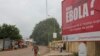 FILE - A billboard with a message about Ebola appears on a street in Conakry, Guinea, Oct. 26, 2014.