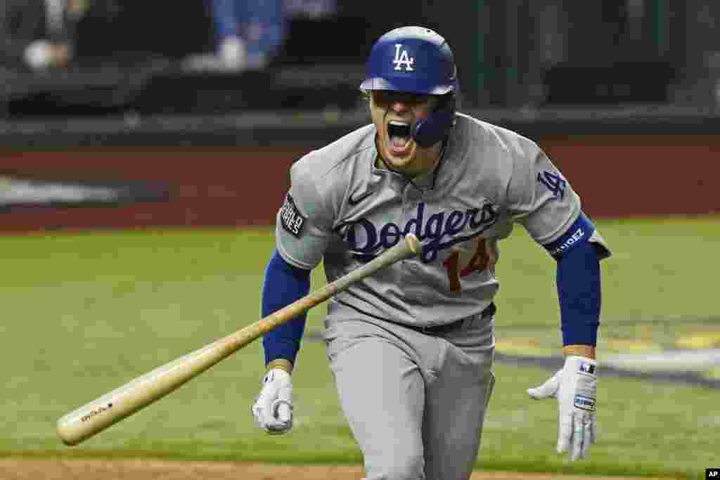 Los Angeles Dodgers&#39; Enrique Hernandez celebrates a RBI-double against the Tampa Bay Rays during the sixth inning in Game 4 of the baseball World Series, Oct. 24, 2020, in Arlington, Texas.