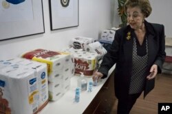 Maria Thereza Sombra, an 81-year-old former teacher who heads the neighborhood association in Rio’s tony Morro da Viuva area, shows items donated by residents to the local police station in Rio de Janeiro, Brazil, June 17, 2016.