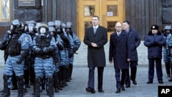 Lawmaker and chairman of the Ukrainian opposition party Udar (Punch), Vitaly Klitschko, centre left, walks with Arseniy Yatsenyuk, centre, and Oleg Tyagnibok, centre right, as they could not get entry into a government building, Nov. 27, 2013.