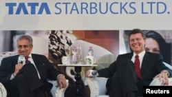 Vice Chairman of Tata Global Beverages R.K. Krishna Kumar and President of Starbucks China and Asia Pacific John Culver (R) attend a news conference in Mumbai, January 30, 2012. 