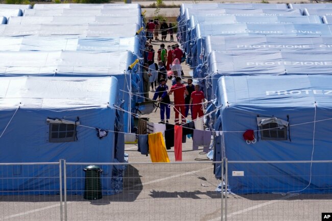 FILE - Afghan refugees are seen in an Italian Red Cross refugee camp, in Avezzano, Italy, Aug. 31, 2021.