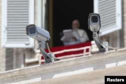 Security cameras are seen in front of Pope Francis as he leads a Sunday Angelus prayer in Saint Peter's square at the Vatican, Aug. 20, 2017.