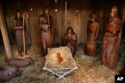 FILE - Carved wooden figures populate the Nativity scene on the Arkansas state Capitol grounds in Little Rock, Dec. 17, 2007.