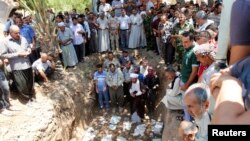 Mourners pray during a funeral in Kirkuk, June 23, 2014. Relatives of the deceased said that about 15 Iraqi Turkmen Shi'ites were killed by militants from the Islamic State in Iraq and the Levant [ISIL] in Tuz Khurmato.