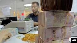 FILE - Vietnamese money Dong is seen in Asia Commercial Bank in Hanoi, Vietnam. (AP Photo/Chitose Suzuki)