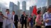 Pro-Beijing supporters hold flags and placards during a rally in support of the legislative election in Hong Kong, Dec. 16, 2021. 