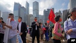 Pro-Beijing supporters hold flags and placards during a rally in support of the legislative election in Hong Kong, Dec. 16, 2021. 