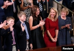 U.S. House Speaker Paul Ryan's family, from left, sons Sam and Charlie, daughter Liza, wife Janna and mother Elizabeth, wave to him from the gallery during the election in the House Chamber in Washington, Oct. 29, 2015.