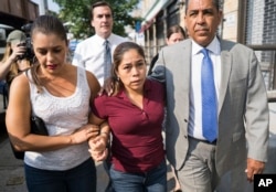 Yeni Gonzalez, center, a Guatemalan mother who was separated from her three children at the U.S.-Mexico border arrives, July 3, 2108 to reunite with them in New York. A team of volunteers drove Gonzalez from Arizona after she was released from Eloy Detention Center.