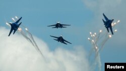 FILE: Sukhoi Su-27 jet fighters of the Russkiye Vityazi (Russian Knights) aerobatic team fly in formation during the International Army Games 2016, in Dubrovichi outside Ryazan, Russia, August 5, 2016. 