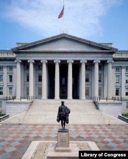 A statue of Alexander Hamilton in front of the Treasury Building in Washington, D.C.