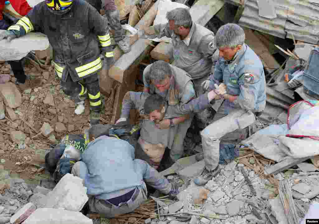 A man is rescued alive from the ruins following an earthquake in Amatrice, Aug. 24, 2016.