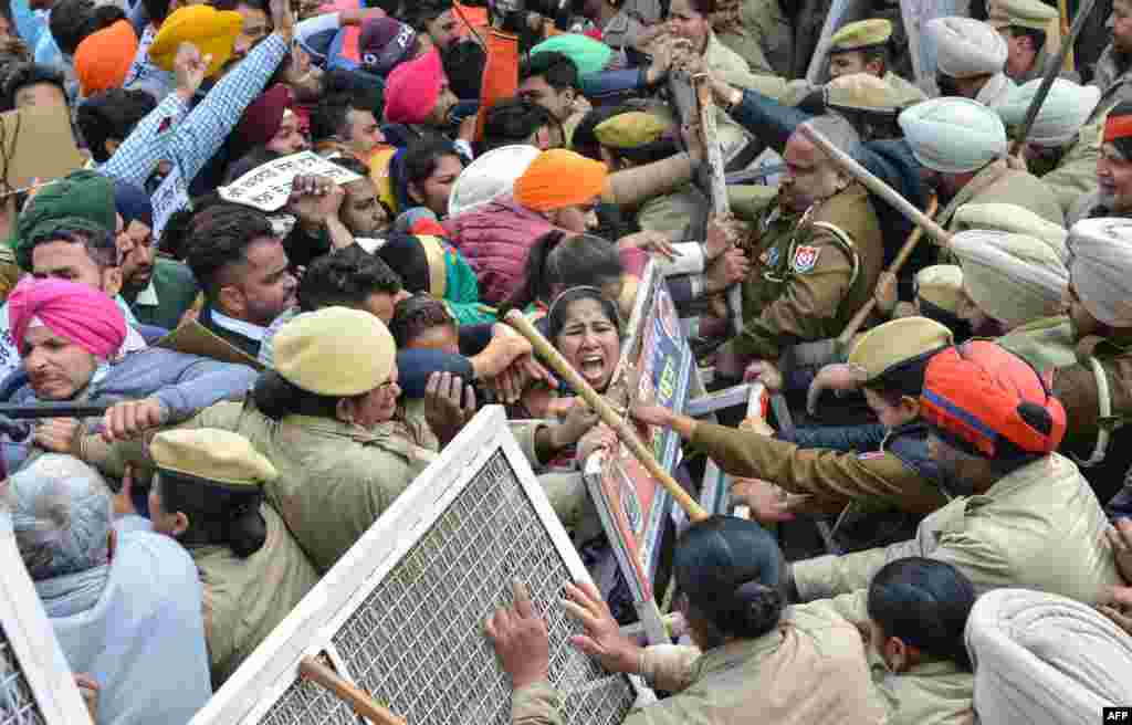Indian police block unemployed teachers as they march towards the residence of Punjab Education Minister Om Parkash Soni during a protest to demand jobs in Amritsar.