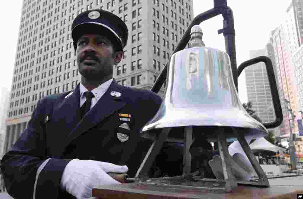 Detroit Fire Department Lt. Gerod Funderburg rings a bell during a ceremony in Detroit, Sept. 11, 2013, marking the 12th anniversary of the 9/11 terrorist attacks.