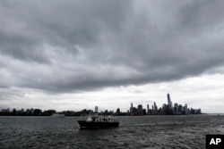 A boat passes Pier A Park on the Hudson River with the New York skyline in the background, Sept. 30, 2015. Officials along the Eastern Seaboard are taking precautions for the rest of the week as forecasters closely follow Hurricane Joaquin.