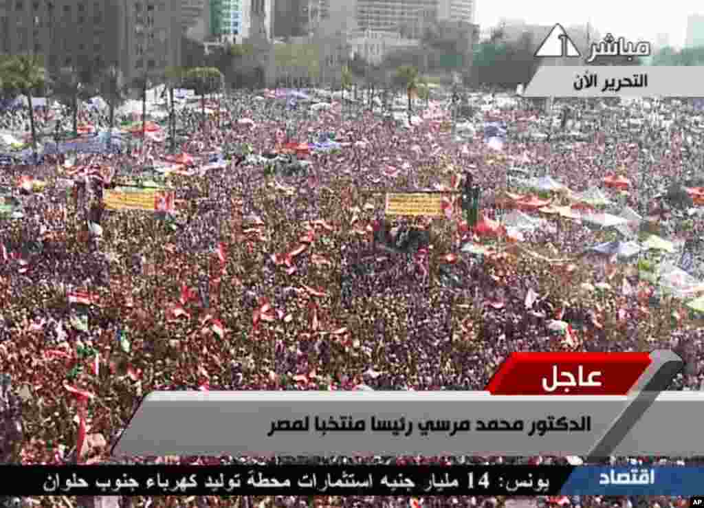 In this image taken from Egypt State TV, Supporters of Muslim Brotherhood President Mohammed Morsi react to the announcement of his victory in Tahrir Square in Cairo, Egypt, June 24, 2012. (Reuters)