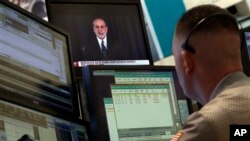 Trader Justin Flinn watches Fed Chairman Ben Bernanke on a screen on the floor of the New York Stock Exchange, June 19, 2013.