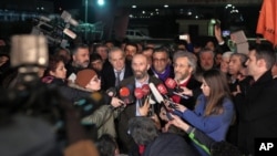 Can Dundar, the editor-in-chief of opposition newspaper Cumhuriyet, center right, and Erdem Gul, the paper's Ankara representative, center left, speak to the media outside Silivri prison near Istanbul, after their release, Feb. 26, 2016.