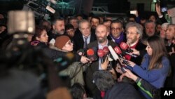 Can Dundar, the editor-in-chief of opposition newspaper Cumhuriyet, center right, and Erdem Gul, the paper's Ankara representative, center left, speak to the media outside Silivri prison near Istanbul, after their release early Friday, Feb. 26, 2016.