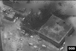 The site of an al-Qaida senior leader meeting in al-Jinah, Syria, is shown after being hit by an airstrike March 16. The photo shows what appears to be an intact, undamaged mosque next to a larger building that apparently suffered multiple weapons strikes