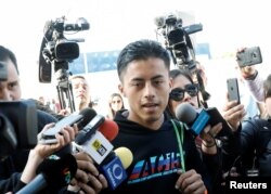 A Honduran man seeking asylum is surrounded by reporters after being sent back to Mexico by the U.S. at the Chaparral border crossing in Tijuana, Mexico, Jan. 30, 2019.