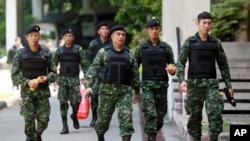 FILE - Thai soldiers walk after being deployed to guard at Bangkok's Victory Monument, Thailand, June 8, 2014.