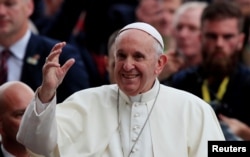 Pope Francis waves as he attends the Festival of Families at Croke Park during his visit to Dublin, Ireland, Aug. 25, 2018.