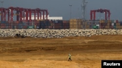 FILE - An engineer walks through a part of a construction site of Chinese investment "Colombo Port City" in Colombo, February 20, 2015.