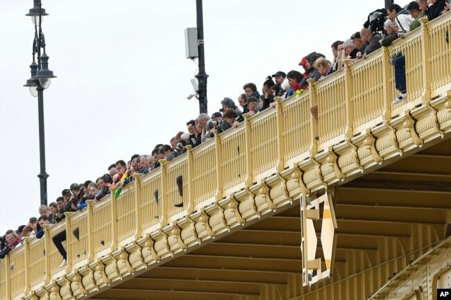 People stand on the Margaret Bridge to watch the recovery operations for a capsized boat in Budapest, Hungary, May 30, 2019.