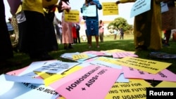 FILE - Supporters of the anti-gay law prepare for a procession backing the signing of the anti-gay bill into law, in Uganda's capital, Kampala.