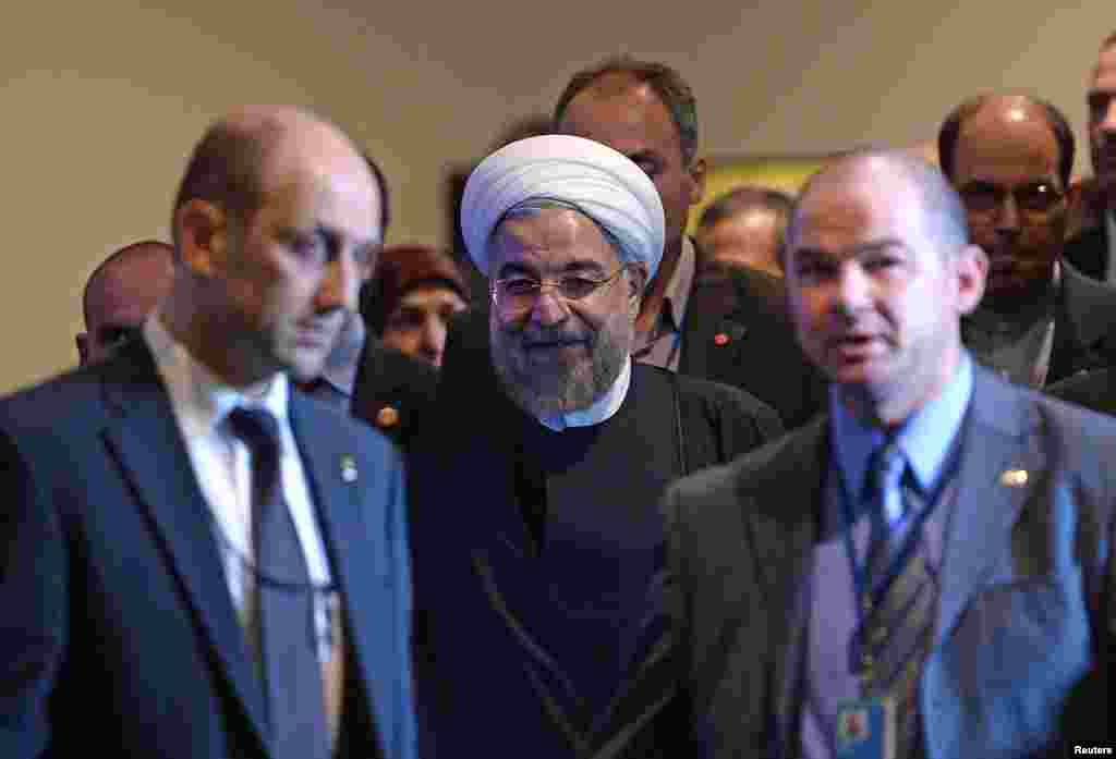 Iran's President Hassan Rouhani (center) is escorted for a meeting with U.N. Secretary-General Ban Ki-moon on the sidelines of the U.N. General Assembly in New York, Sept. 23, 2014.